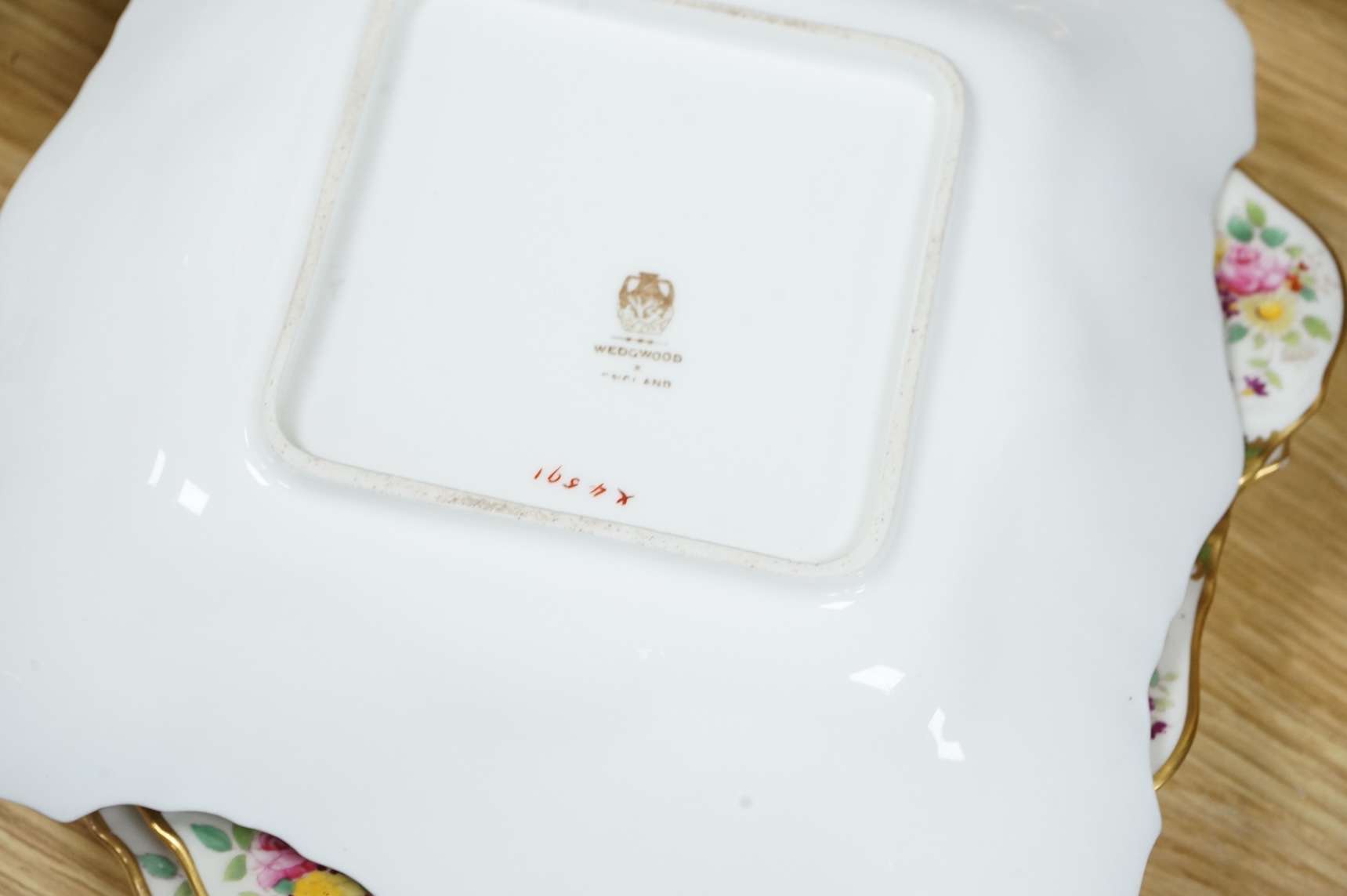 An early 20th century Wedgwood gilt and floral decorated dessert service, oval dishes 26cm wide (18).